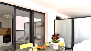 A dining area with a table, chairs, and a flower vase.