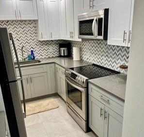 Fridge, microwave, oven, stovetop - Beachfront ground floor condo with deck and heated pool
 (Cocoa Beach)