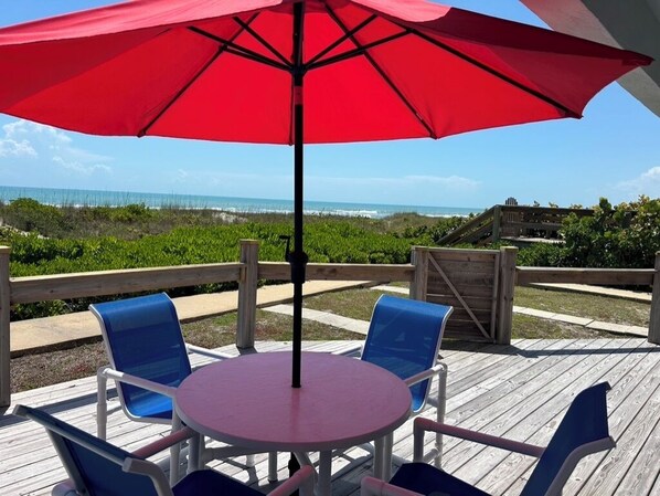 Outdoor dining - Beachfront ground floor condo with deck and heated pool
 (Cocoa Beach)