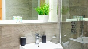 A modern bathroom with a white sink, a mirror, a potted plant, and a glass shower enclosure. - The Ridgmont-st Albans-high Street- Near Luton Airport -train Station-balcony (St Albans)