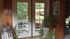 A wooden door with glass panels, a potted plant, and a framed picture on the wall. - Updated farmhouse on 5 acres near salem oregon (Jefferson)