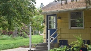 A yellow house with a blue door and white steps leading up to it. - Updated farmhouse on 5 acres near salem oregon (Jefferson)