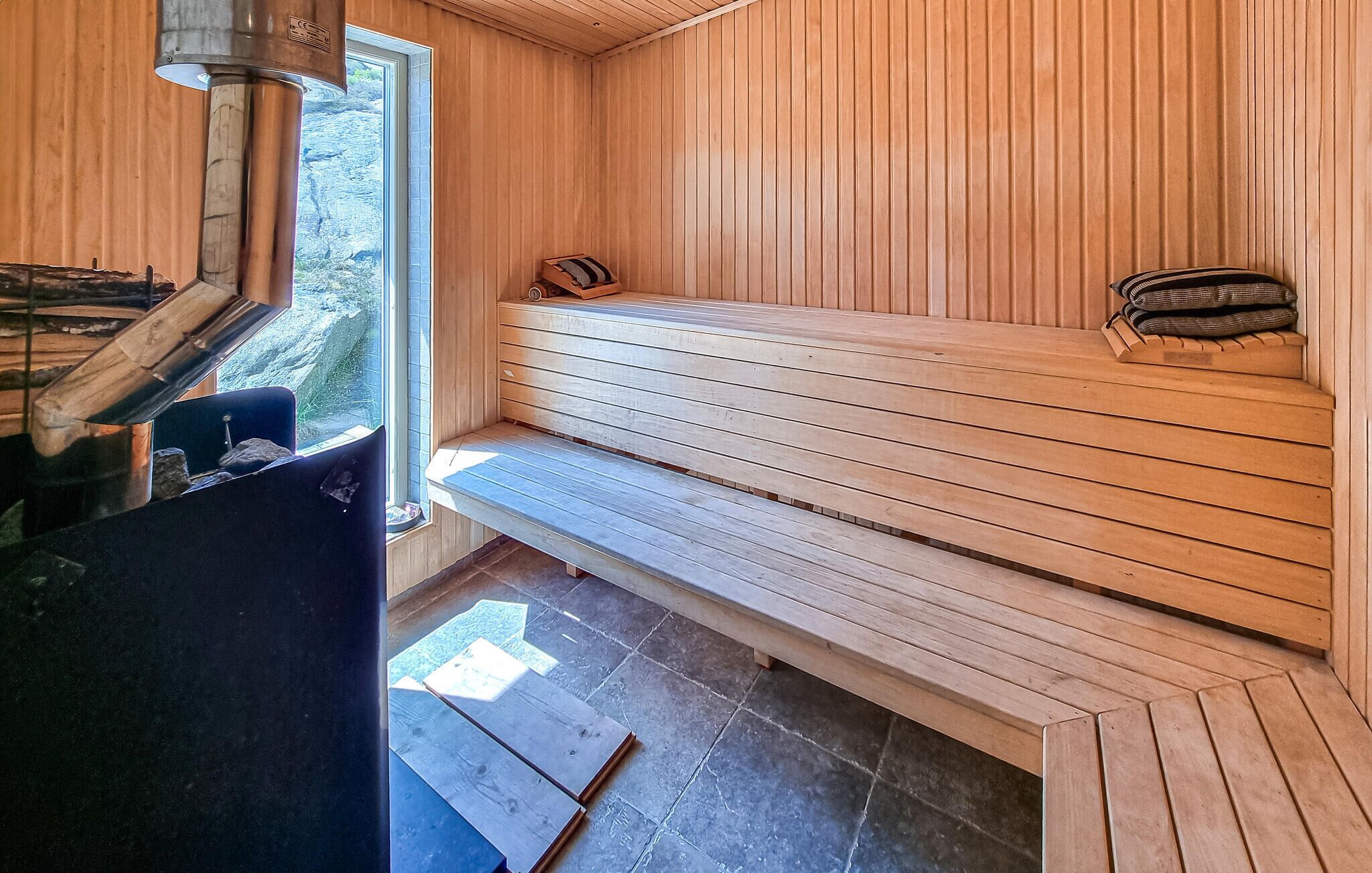 Un sauna avec des bancs en bois et un banc muni d’une serviette.