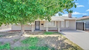 A single-story house with a front door, a small porch, and a garage. - 4 beds 2 baths in Las Vegas
 (Las Vegas)
