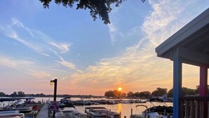 A marina with boats docked at wooden piers during sunset. - !Newly Upgraded! Hot Tub-Game Room-Dock-Fire Pits (Millersport)