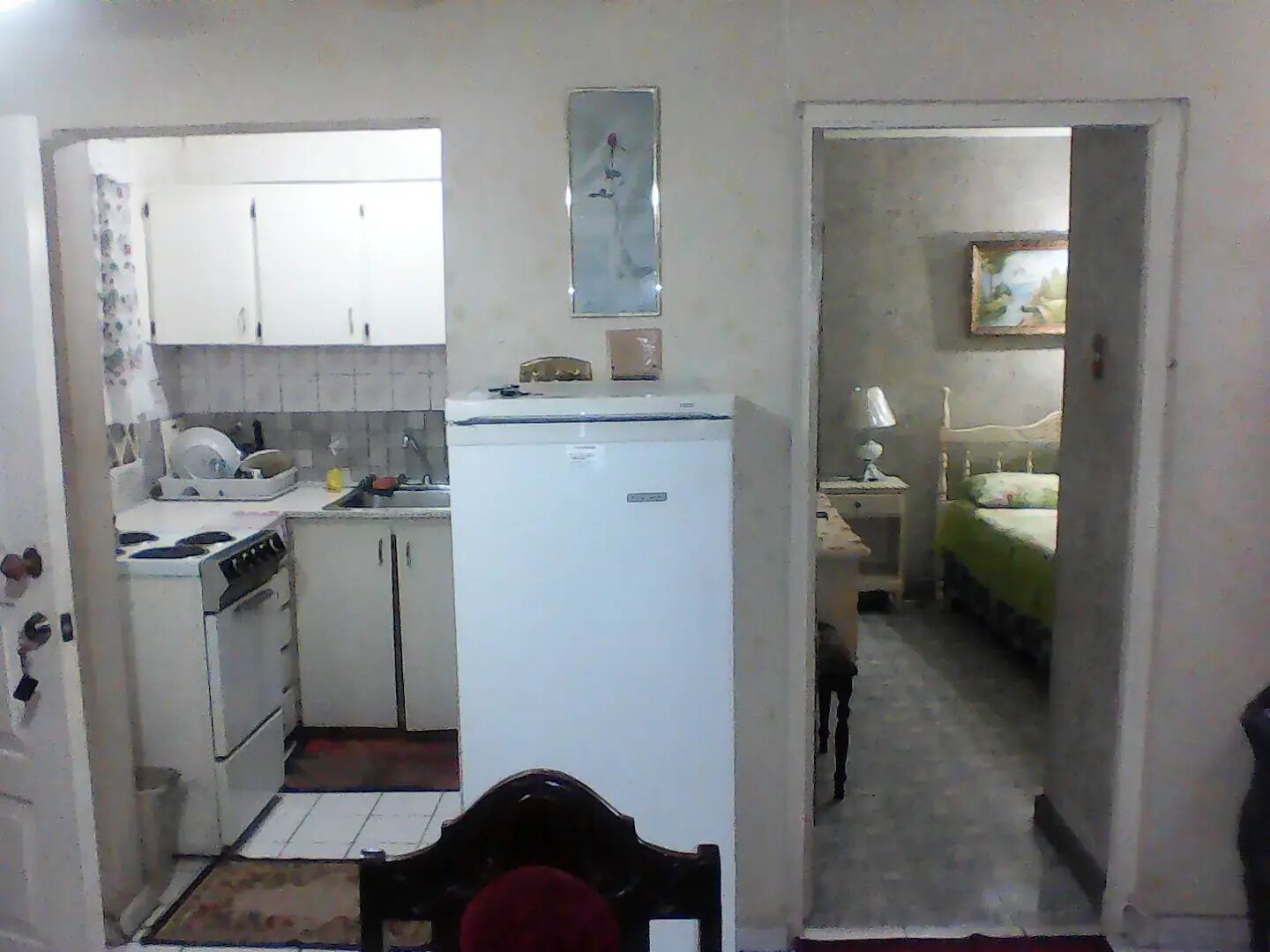 A compact kitchen with basic appliances and a dining area.