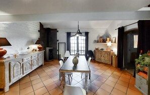 Enjoy cooking and dining in this well-equipped kitchen with a central island, dining table, and chairs.