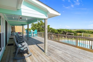 Large Back Deck overlooking the pool with an ocean view. Shade all day!