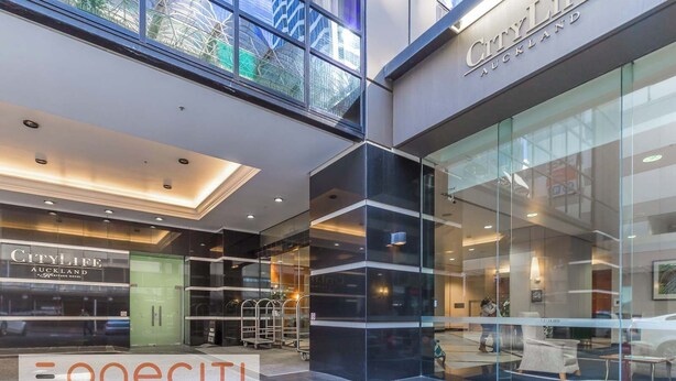 A modern hotel with a glass facade, a prominent CityLife Auckland sign, and a visible Heritage Hotel sign. - Highrise studio w AC, Pool and Gym in Auckland CBD (Auckland)