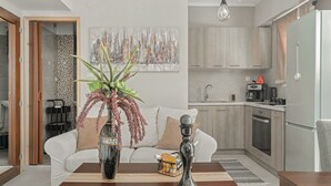 Una cocina moderna con armarios de madera, encimera blanca y horno empotrado.