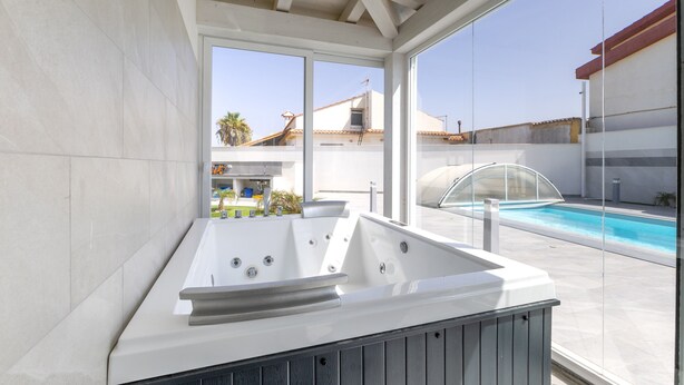 A modern outdoor hot tub area with a clear view of the pool and surrounding buildings. - Villa 'Maria Con Piscina Riscaldata' with Sea View, Wi-Fi and Air Conditioning (Santa Maria del Focallo)