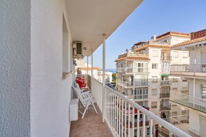 A balcony with white railings, a tiled floor, and a view of adjacent buildings. - Apartment 'Sol Marengo Torrecilla Nerja' with Sea View, Wi-Fi and Air Conditioning (Nerja)