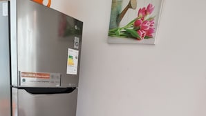 A stainless steel refrigerator with a sticker indicating energy efficiency. - Cabañas Aquila D'Arroscia (Caldera)