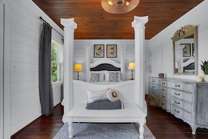 A bedroom with a four-poster bed, a dresser, and a mirror. - Romantic Golden Valley Cottage | View of Amish Countryside + Walk to Amish Eats (Sugarcreek)