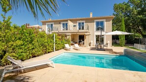 A two-story house with a swimming pool, outdoor furniture, and a well-maintained garden. - Villa Julia by Interhome (Les Issambres)