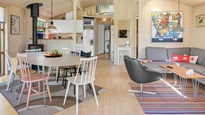 A modern, open-plan living space with a dining area, kitchen, and a cozy seating area with a sofa and coffee table. - "Gligorij" - 450m from the sea by Interhome (Sæby)