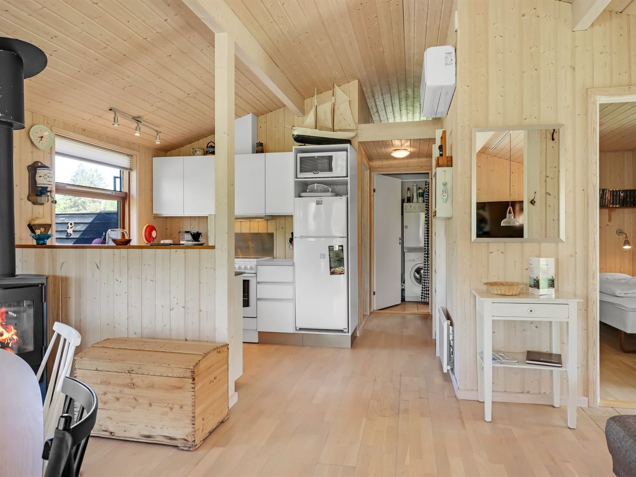 A cozy cabin interior with a kitchen, dining area, and a small living space.
