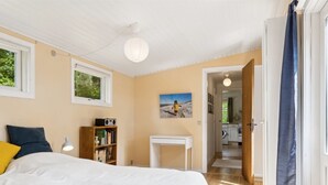 A bedroom with a bed, a bedside table, a bookshelf, and a painting on the wall. - "Heidl" - 1.3km to the fjord by Interhome (Rørvig)