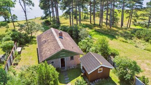 A two-story house with a sloped roof, surrounded by a dense forest and a body of water. - "Uschi" - 86m from the sea by Interhome (Kalundborg)