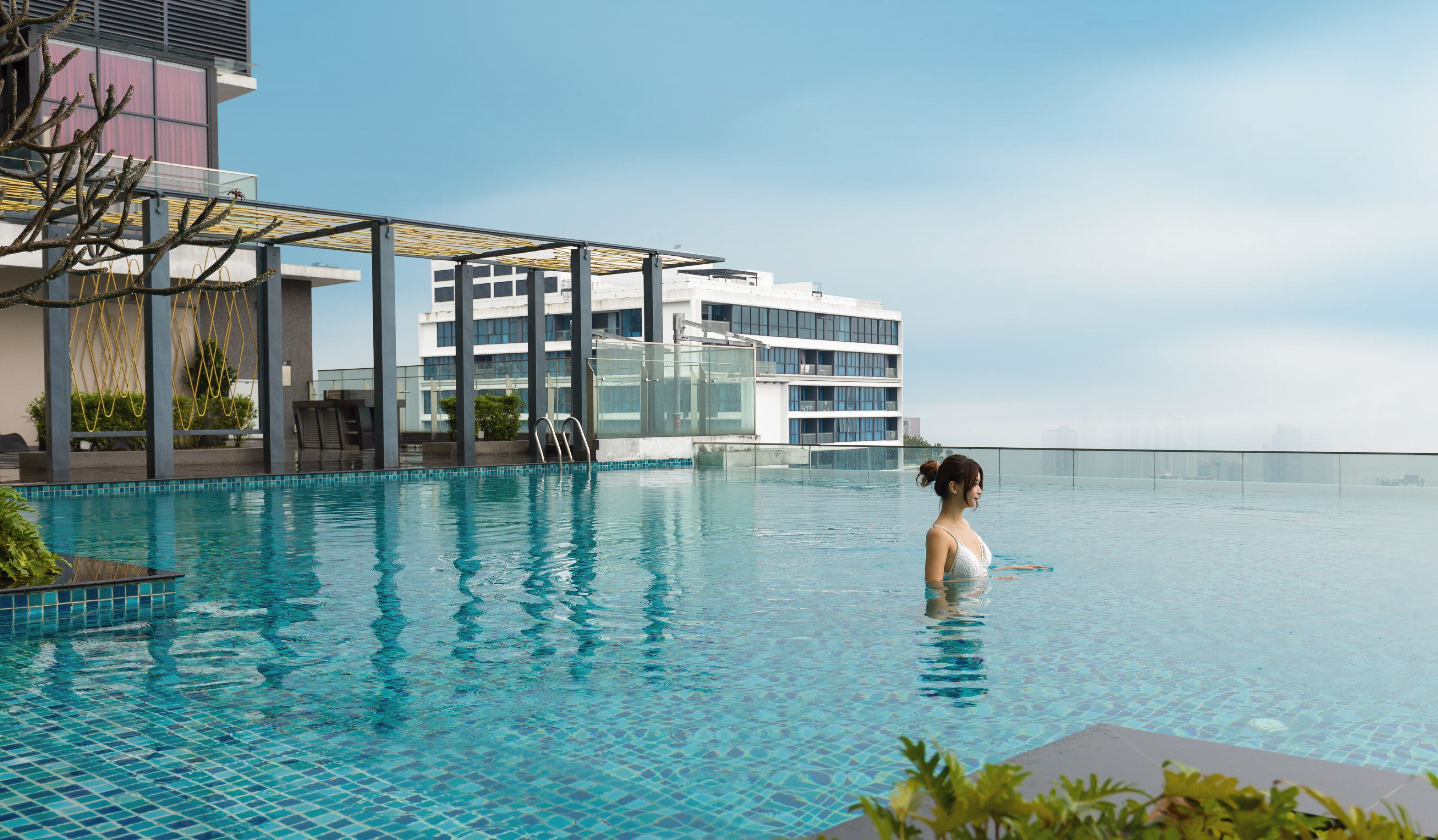A swimming pool with a modern building in the background.
