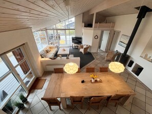 Cozy living space with a central dining table, comfortable seating area, and fireplace.