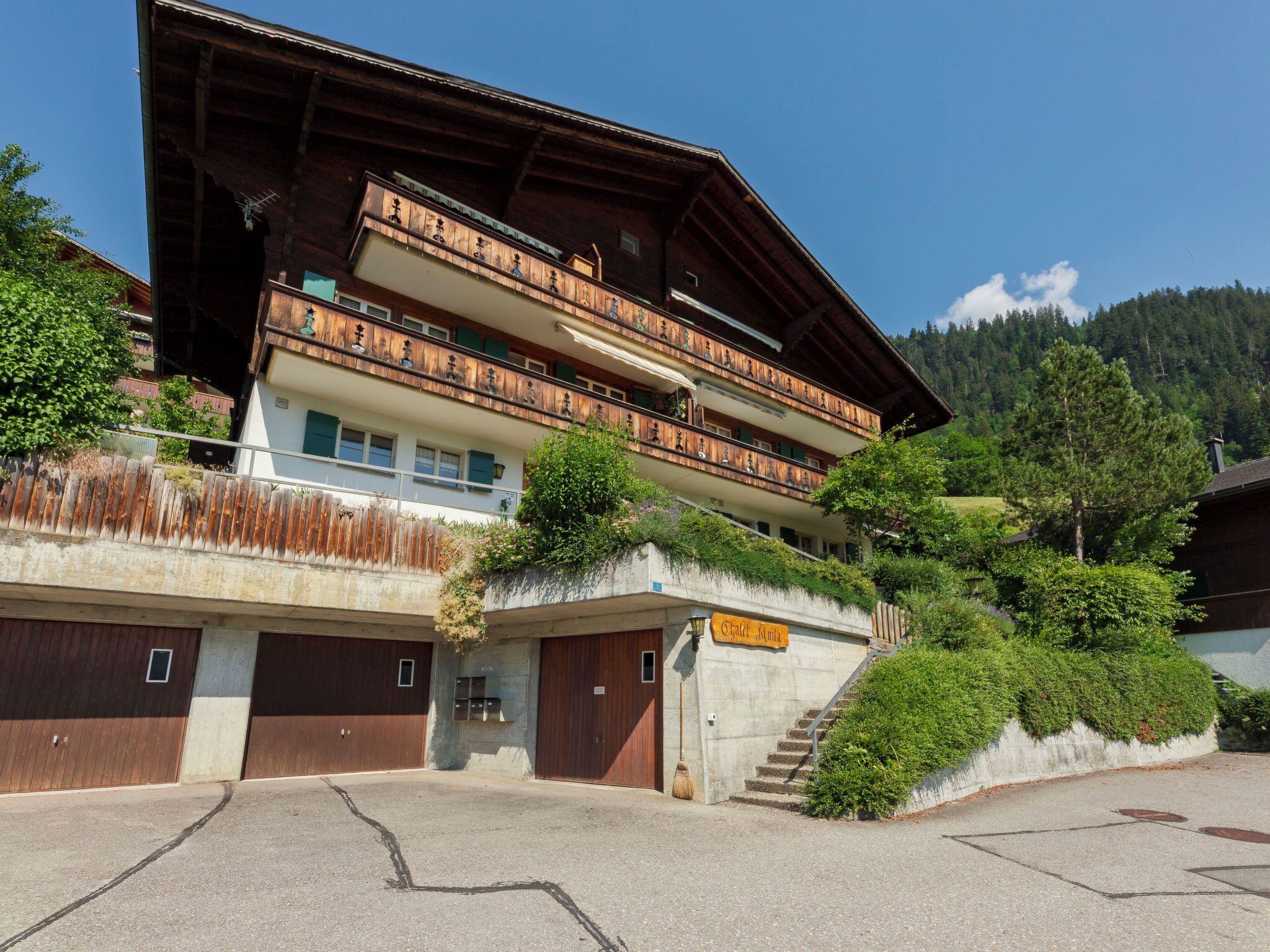 A multi-story hotel with a wooden facade, balconies, and a sign indicating it is a hotel.