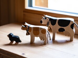 A wooden table with three cow-shaped sculptures.
