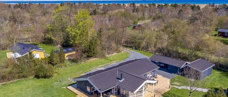 A large house with a deck, a garage, and a swimming pool.