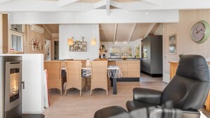 A modern kitchen with a central island, a dining area with wicker chairs, and a leather sofa. - "Anastaja" - 550m from the sea by Interhome (Jerup)