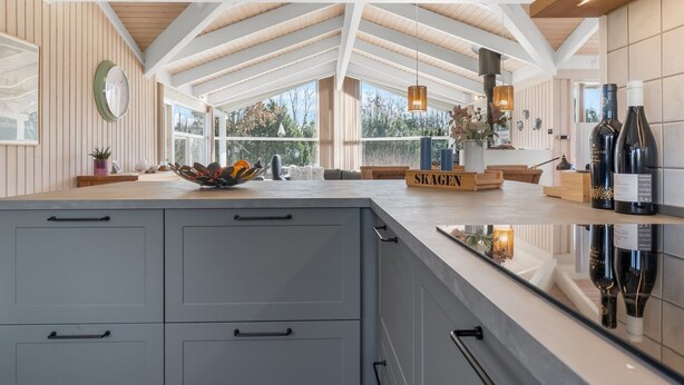 A modern kitchen with a large island, wooden beams, and large windows offering views of the outdoors. - "Anastaja" - 550m from the sea by Interhome (Jerup)