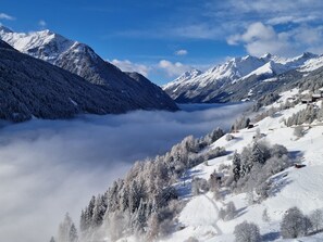 A mountainous landscape with snow-covered peaks and a valley.