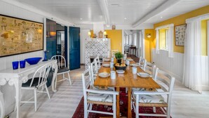 A dining area with a long wooden table, white chairs, and a red rug. - "Wandrath" - 2km from the sea by Interhome (Blåvand)