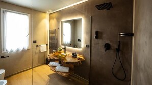 A modern bathroom with a wooden vanity, a glass sink, a large mirror, and a walk-in shower. - Master bedroom with terrace (San Costantino di Briatico)