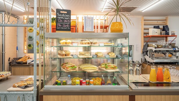 A bakery counter with various baked goods and beverages. - UCPA Sport Station Hostel Paris (Paris)