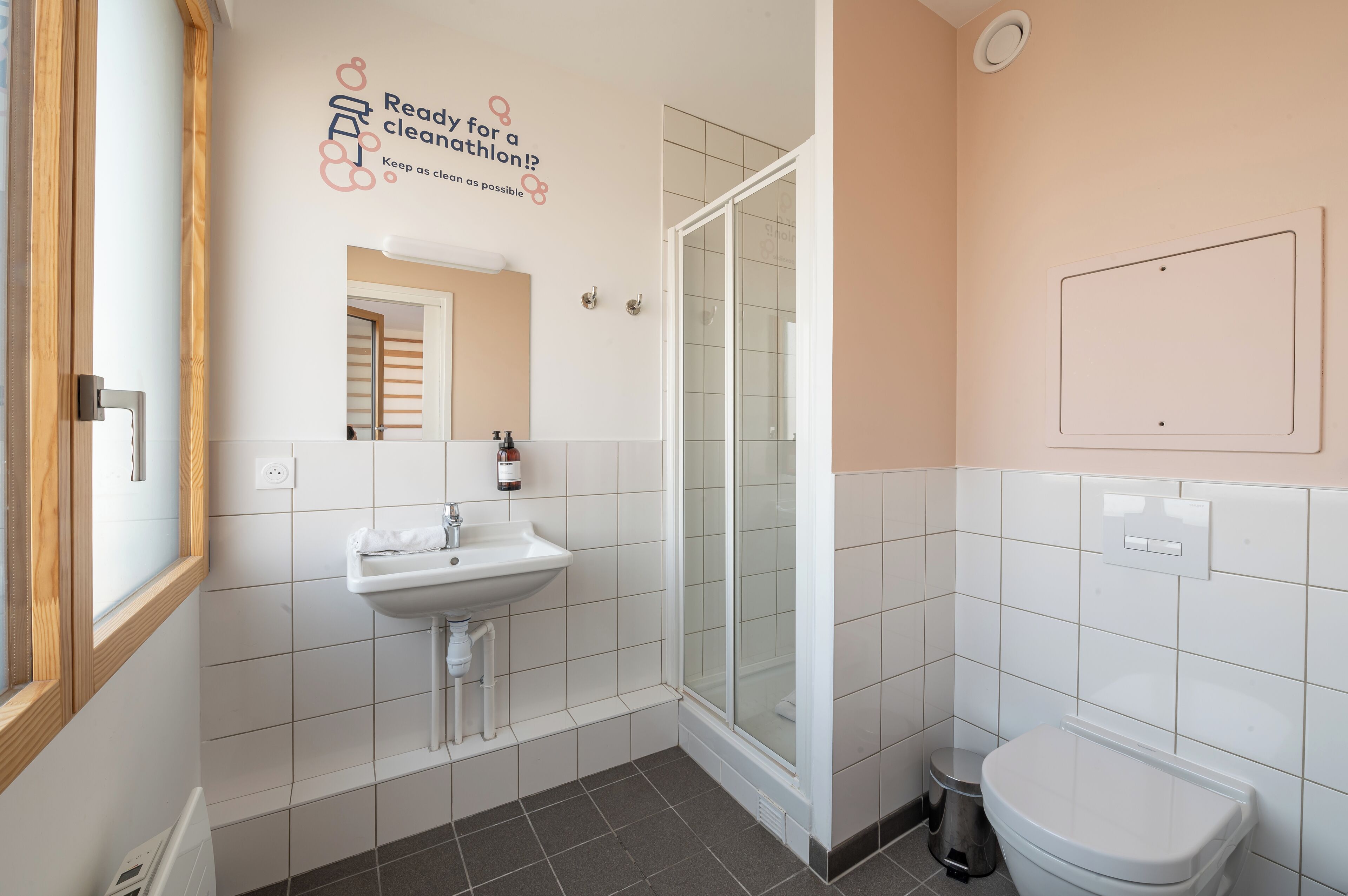 A modern bathroom with a sink, mirror, and toilet.