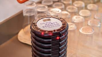 A stack of black luggage with a label reading "UCPA Sport Station Hostel Paris".