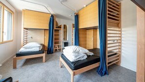 A room with bunk beds, a desk, and a chair. - UCPA Sport Station Hostel Paris (Paris)