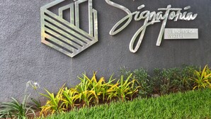 A wall with a logo and text reading "Signatory" and "By Foreshore Waters". - Luxury 3 bedroom, Secure, Water View, 24/7 Power in secluded estate - Ikoyi  (Lagos)