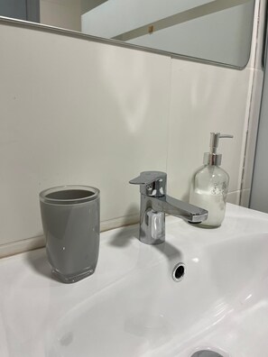 Secador de cabelo, toalhas de banho, sabonete, papel higiênico