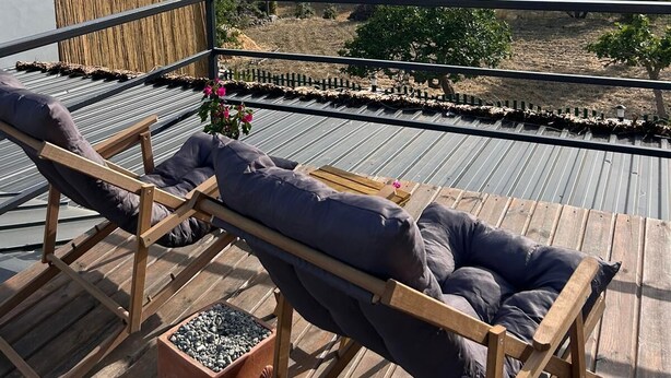 A wooden deck with two lounge chairs and a small planter. - Era House (Marmaris)