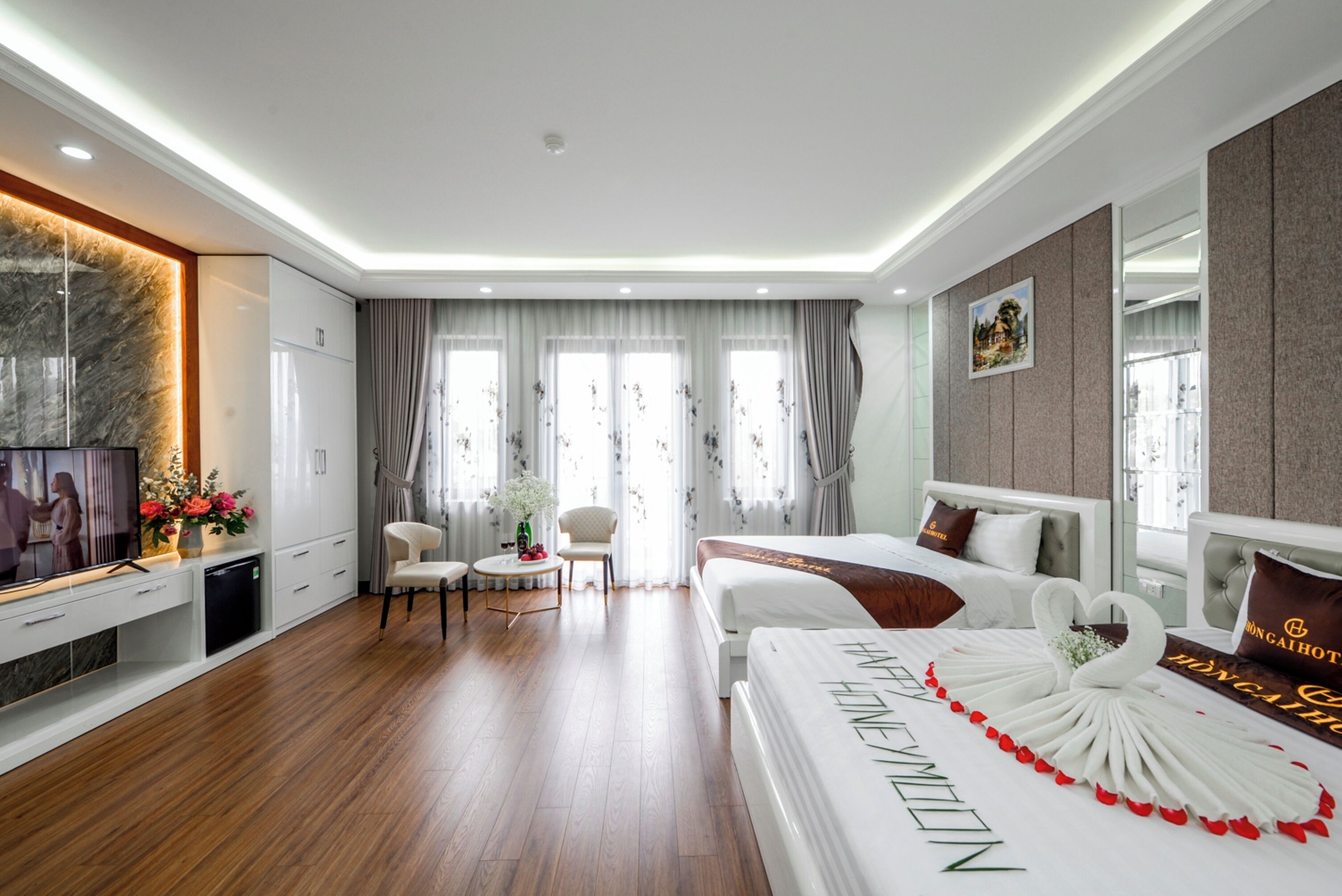 Una habitación de hotel con una cama, un escritorio, un televisor y una zona de comedor.