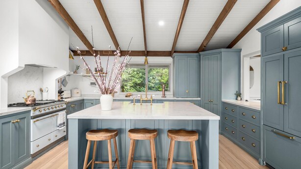 A kitchen with a large island, wooden stools, and blue cabinets. - Woolrich House - Woolrich House at Woolrich Estate (Olinda)