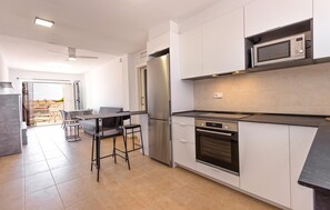 Enjoy meals in the kitchen with a dining area and balcony offering city views.