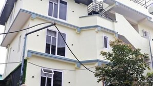 A multi-story hotel with a flat roof, multiple windows, and a gated entrance. - Hotel Royal Emperor (Kathmandu)