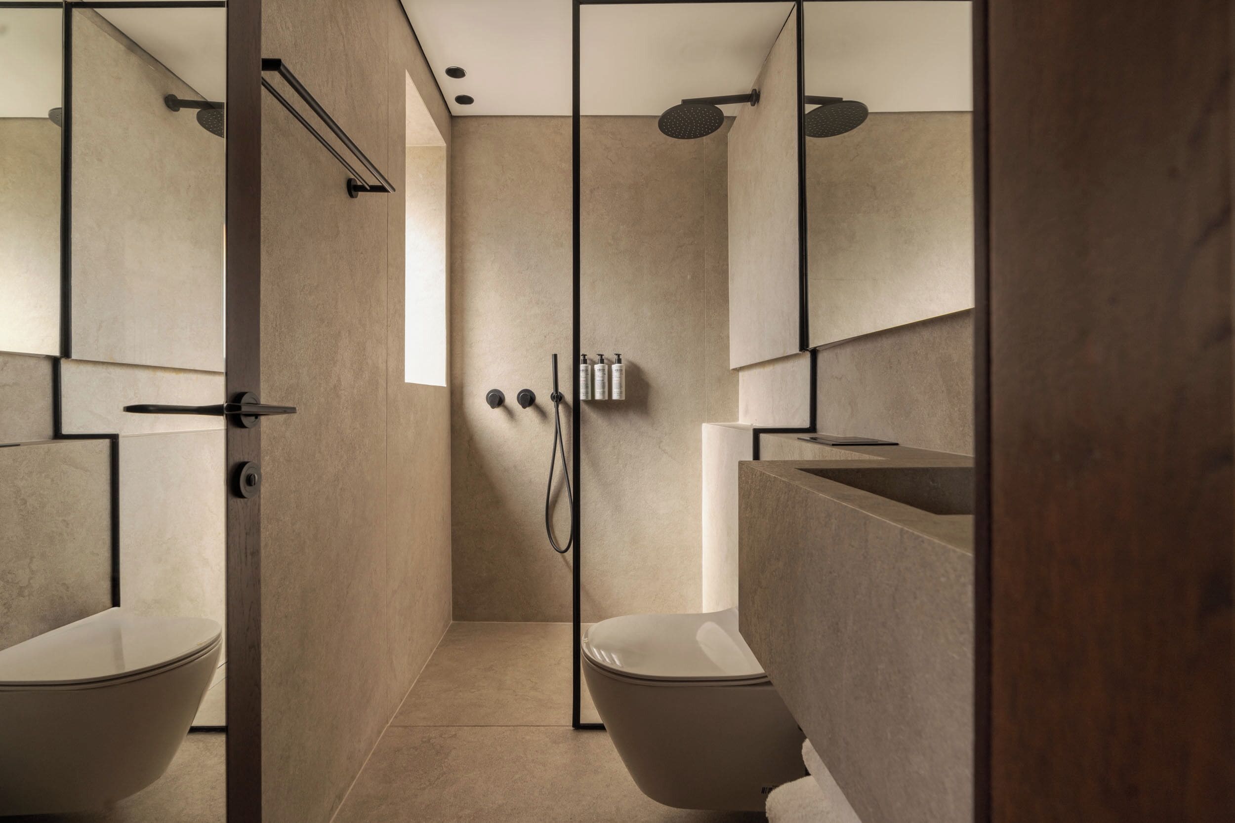 A modern bathroom with a freestanding bathtub, a separate toilet, and a shower area.
