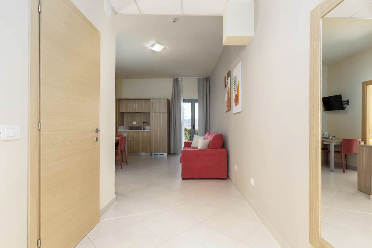 A modern apartment with a kitchen, dining area, and living room.