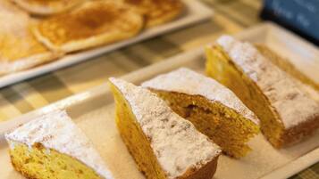 Slices of cake with powdered sugar on a plate.