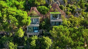 Two glass-roofed cabins nestled among lush greenery on a hillside. - Scappa Resort (Ajaltoun)