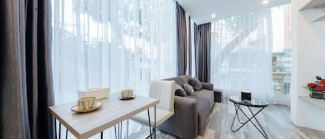 City Apartment | Living area | 42-inch Smart TV with cable channels