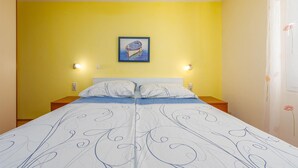 A room with a bed, two bedside tables, a wall-mounted light, and a painting above the bed. - 2 bedroom lovely apartment in Vir (Vir)